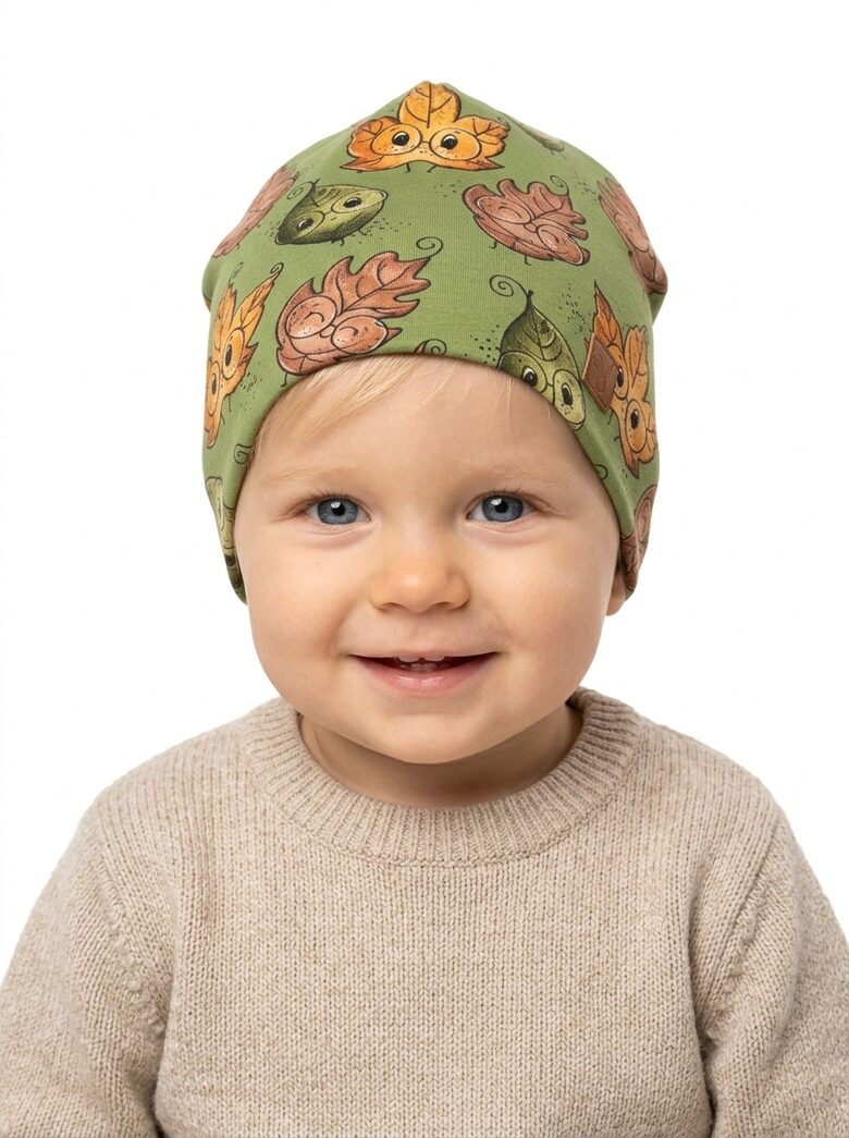Starpsezonas Beanie cepure 1-2 gadi, krāsainas lapas uz zaļa fona